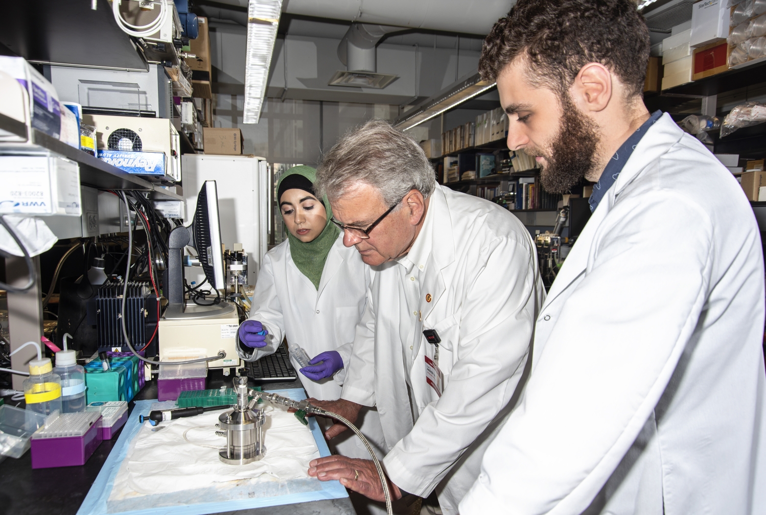 Tri-I M.D.-Ph.D. students and program director in a lab.