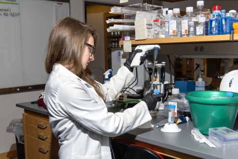 A female M.D.-Ph.D. student working in a lab.