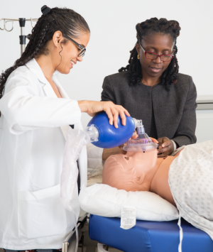 Using a dummy that simulates a patient’s responses, Francesca Voza ’20 (left) practices bagging in the Margaret and Ian Smith Clinical Skills Center with guidance from Dr. Joy Howell, associate professor of clinical pediatrics and vice chair for