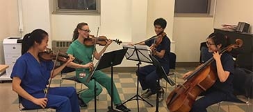 Students playing string instruments